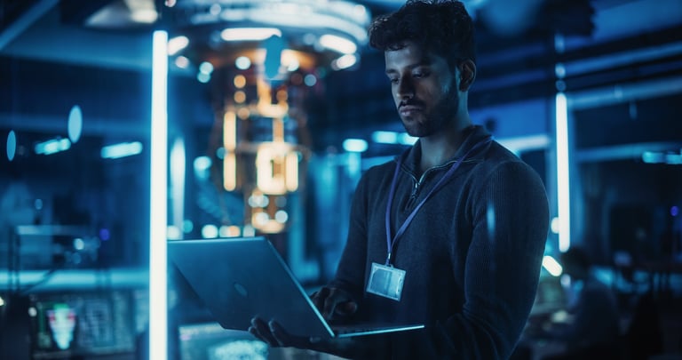 Software developer working on laptop in modern office