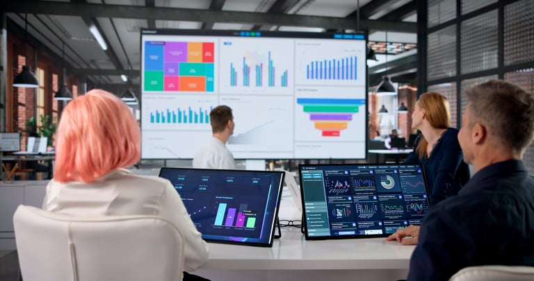Financial Analyst Studies Colorful Data Dashboard During Team Meeting Discussion